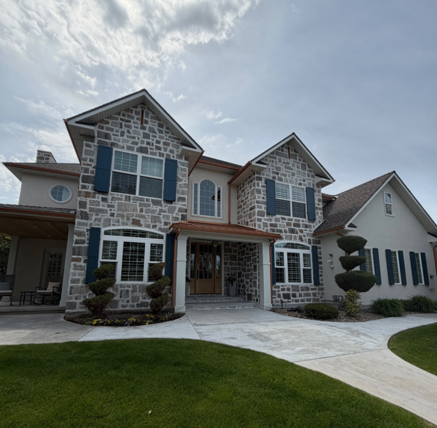 Residential window cleaning project at a large stone-front home
